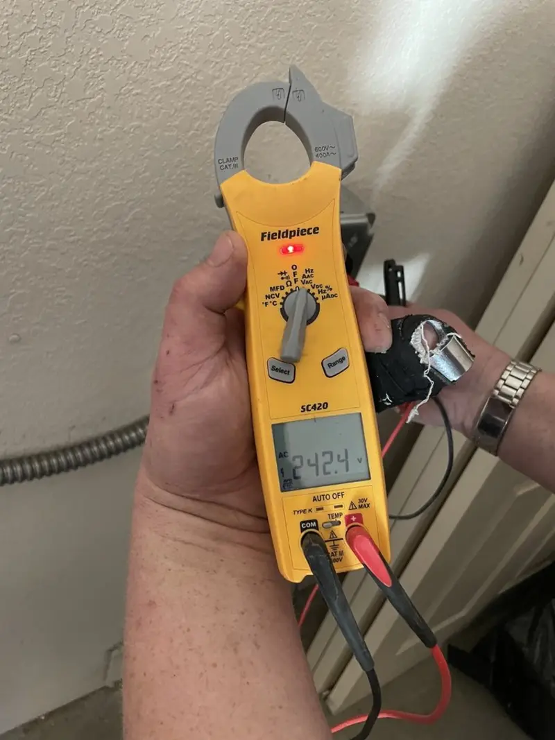 Voltage testing with clamp meter during Ceiling Fan Installation in Southern Shops